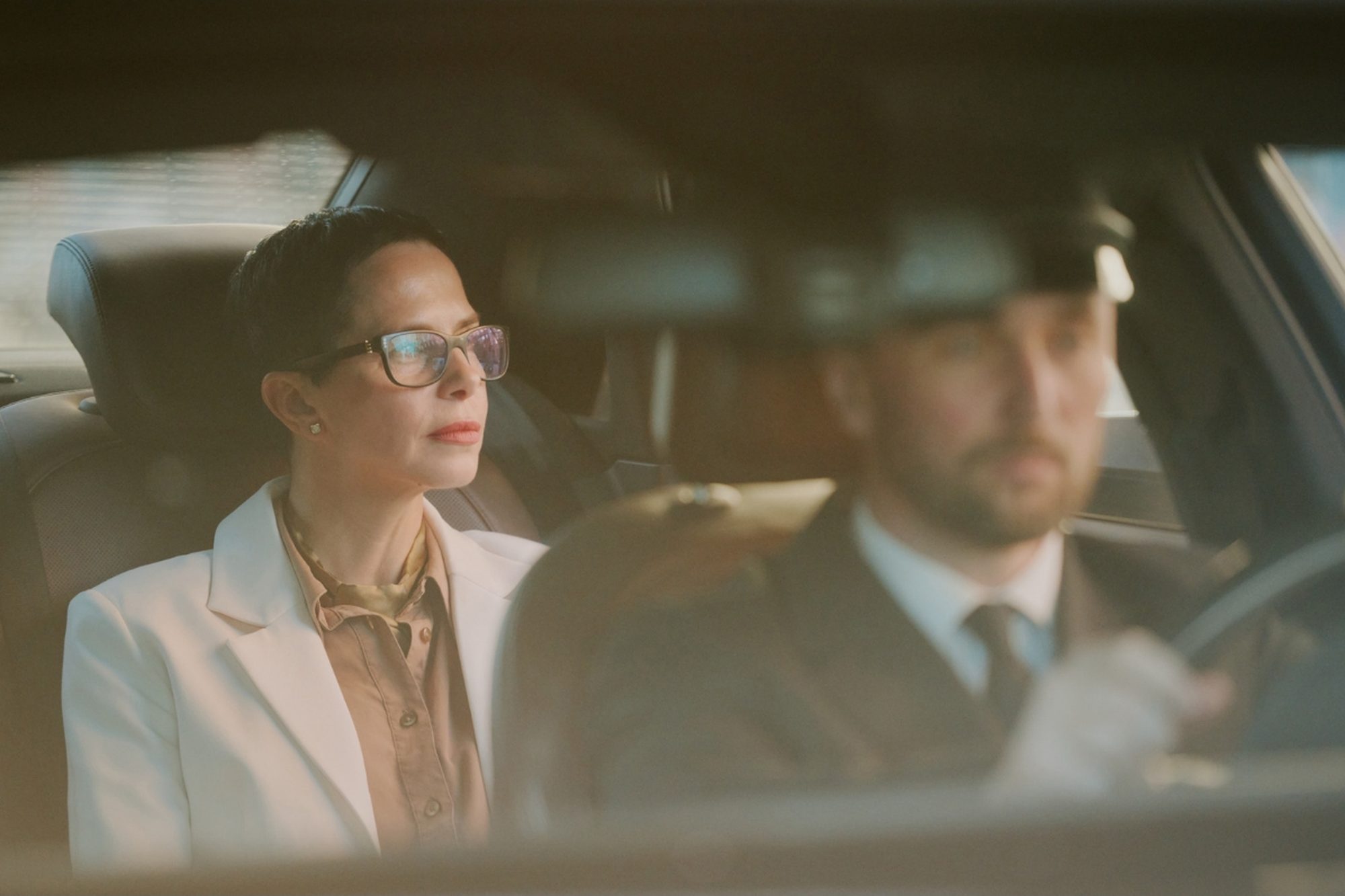 A professional chauffeur driving a guest through Dubai.
