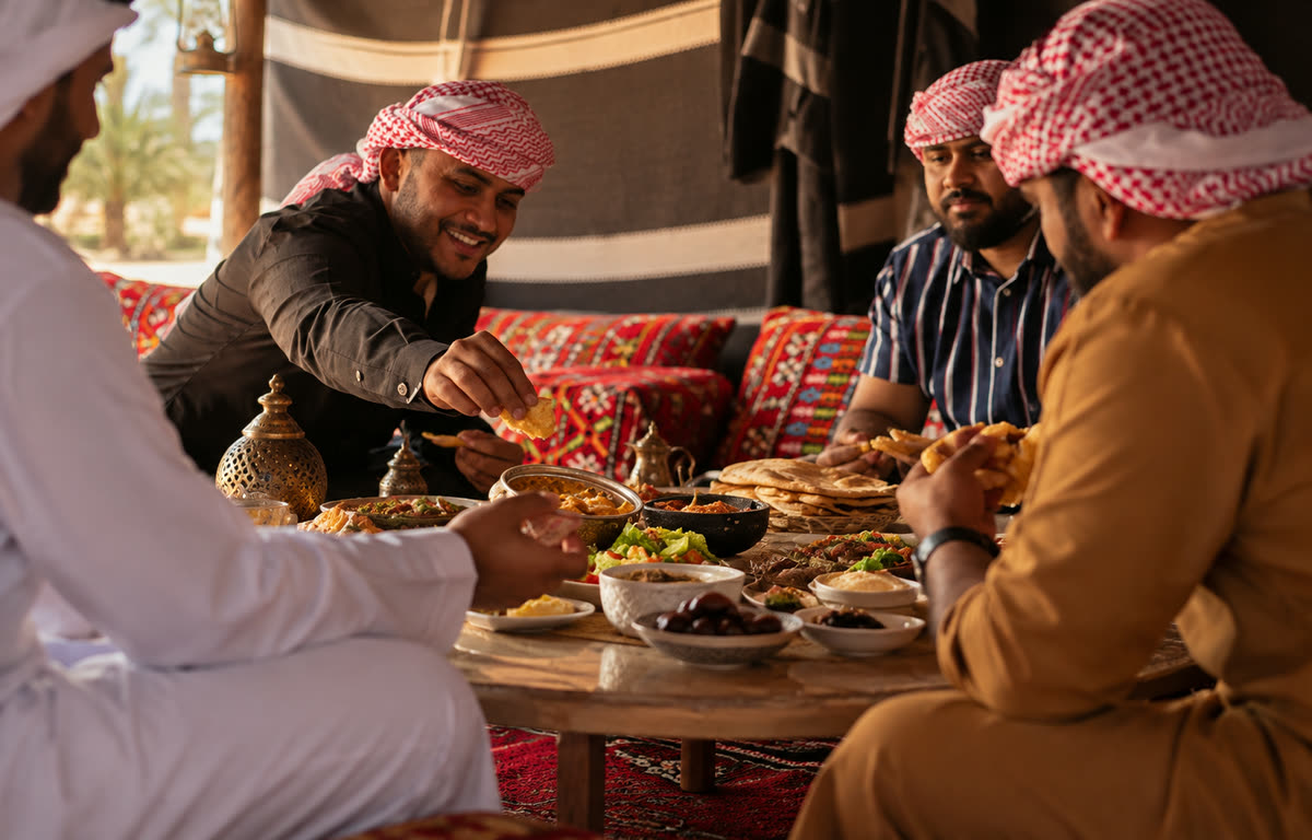 Guests sharing a traditional meal at a Bedouin-style camp