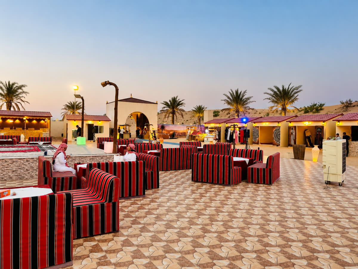 Comfortable cushioned seating arranged around a desert camp